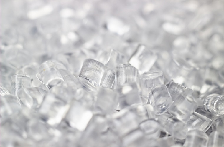 Transparent Plastic in granules. Polymer pellets. Isolated on a black background.